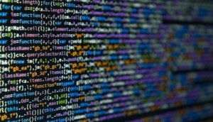 Program code on dark background (selective focus)