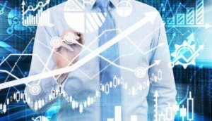 Analyst is drawing a financial calculations and predictions on the glass screen. Graphs, charts and arrows everywhere. A concept of forex market.