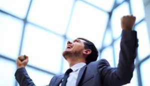 businessman with arms up celebrating his victory