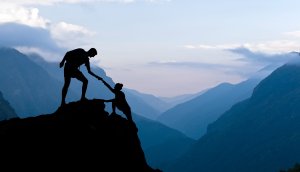 Teamwork Ehepaar helft Hand Vertrauen Hilfe Silhouette in den Bergen, Sonnenuntergang. Team von Bergsteigern Mann und Frau Wandern, helfen einander auf der Bergspitze, schöne Landschaft im Himalaya Nepal