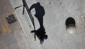 Shadows of people walking a street of the city