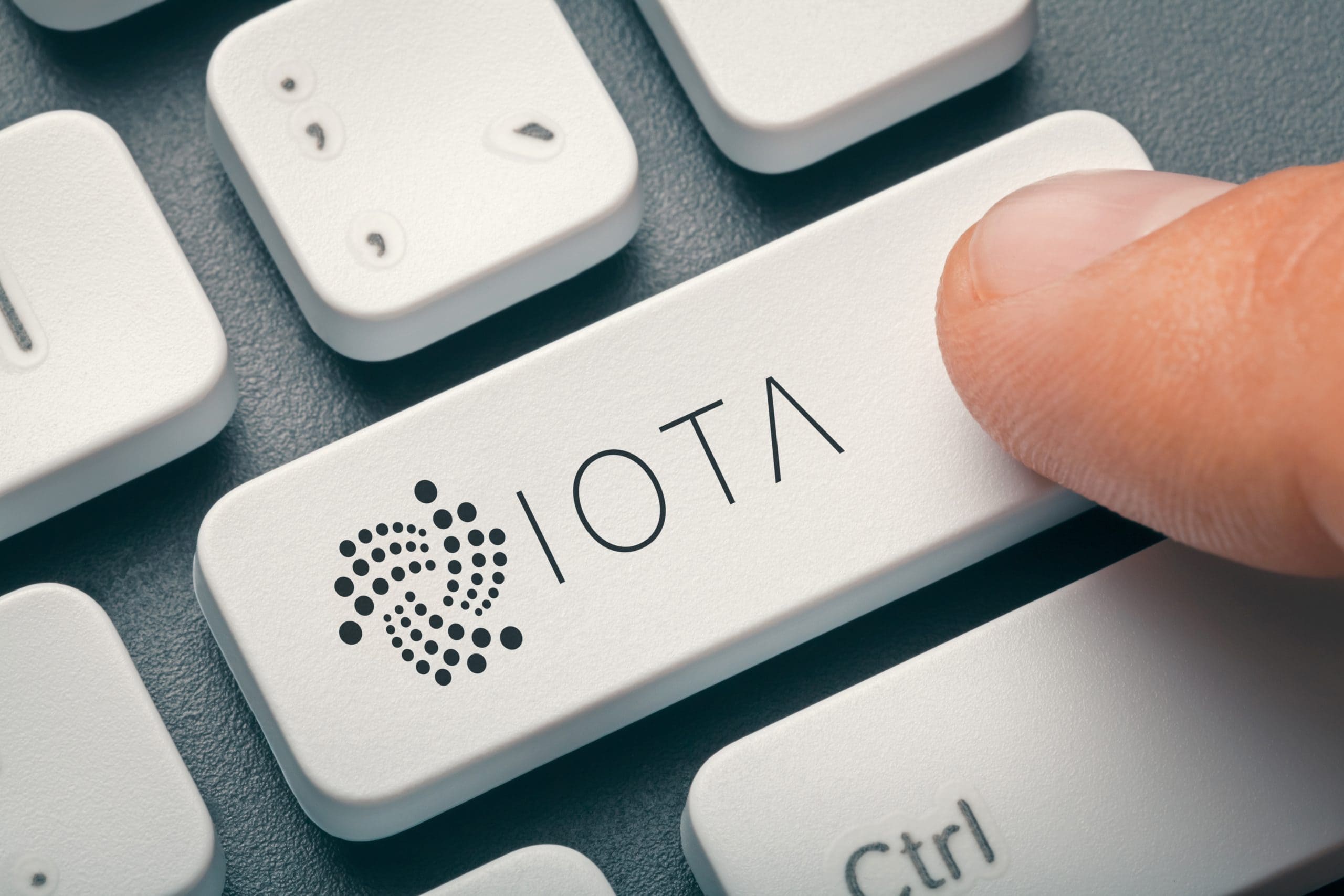 Eine weiße Computer-Tastatur, bei der auf der "Entertaste" IOTA steht.